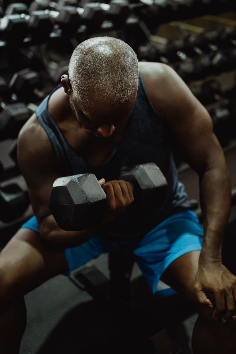Muscular man performing a dumbbell curl