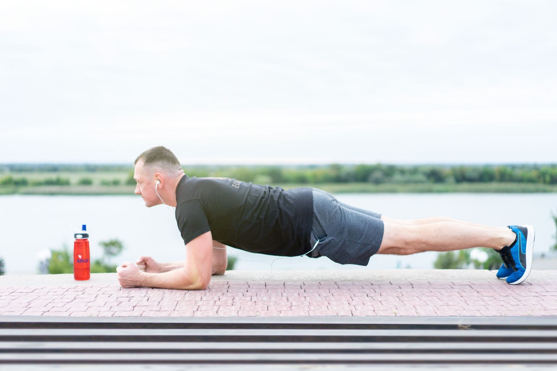 Athletic man holding a plank during an intense fitness session